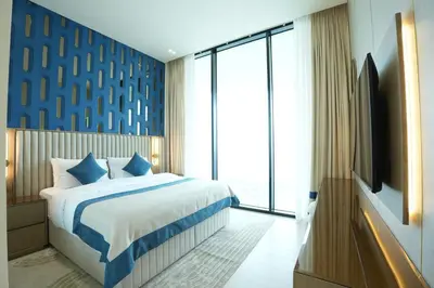 a bedroom with a bed and a television in it at OLD The Royal Blue Jacuzzi Suite 3501 in Dubai