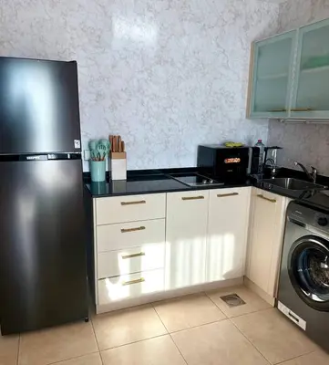 a kitchen with a stainless steel refrigerator and a dishwasher at Dubai Marina 5 min to the beach in Dubai