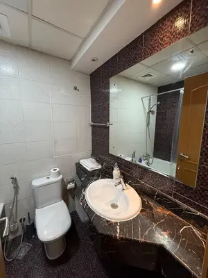 a bathroom with a sink and a toilet and a mirror at Dubai Marina 5 min to the beach in Dubai