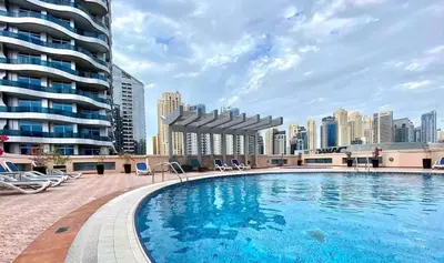 a large swimming pool with a city skyline in the background at Dubai Marina 5 min to the beach in Dubai