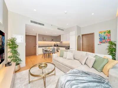 a living room with a couch and a table at Livora Stays - Dubai Marina With Balcony & Water Views in Dubai