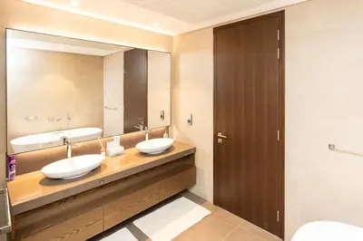 a bathroom with two sinks and a large mirror at CitiHome - Luxurious Marina View - Jumeirah Living in Dubai
