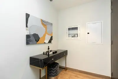 a room with a black desk and paintings on the wall at CitiHome - Luxurious Marina View - Jumeirah Living in Dubai