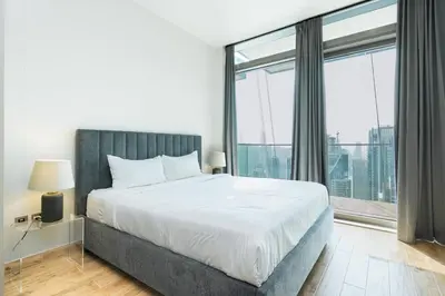 a bedroom with a large bed and a large window at CitiHome - Luxurious Marina View - Jumeirah Living in Dubai