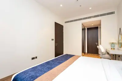 a bedroom with a large bed and a desk at CitiHome - Iconic 1BR Jumeirah Living Marina Gate in Dubai