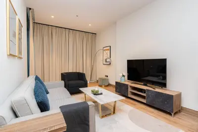 a living room with a couch and a tv at CitiHome - Iconic 1BR Jumeirah Living Marina Gate in Dubai