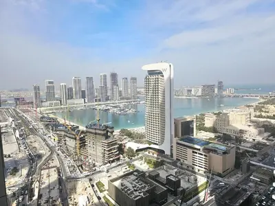 an aerial view of a city with buildings and water at Newly Upgraded 3-BR close to Barasti Beach in Dubai