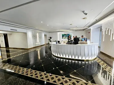 a lobby with a bar in the middle of a building at Newly Upgraded 3-BR close to Barasti Beach in Dubai
