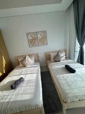 two beds sitting next to each other in a room at 3 bedroom 51st floor Panoramic ocean views in Dubai