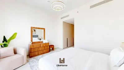 a white bedroom with a white bed and a couch at Direct Burj Khalifa views Lux Sky Manson Like Home in Dubai