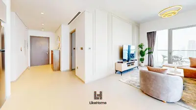 a living room with a couch and a tv at Direct Burj Khalifa views Lux Sky Manson Like Home in Dubai