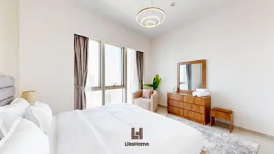 a white bedroom with a large bed and a mirror at Direct Burj Khalifa views Lux Sky Manson Like Home in Dubai