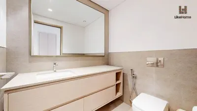 a bathroom with a sink and a mirror and a toilet at Direct Burj Khalifa views Lux Sky Manson Like Home in Dubai