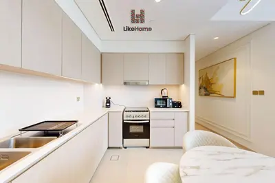 a kitchen with white cabinets and a stove top oven at BEST BURJ VIEW IN DUBAI DOWNTOWN 2BR in Dubai