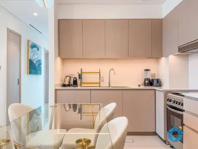 a kitchen with a glass table and chairs at NEXT TO DUBAI MALL AND BURJ 2BR in Dubai