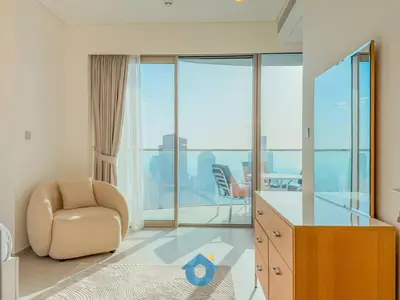 a room with a chair and a desk with a view at NEXT TO DUBAI MALL AND BURJ 2BR in Dubai