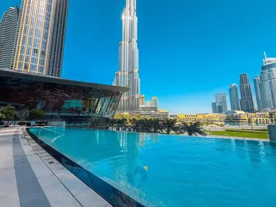 a large swimming pool with a city skyline in the background at NEXT TO DUBAI MALL AND BURJ 2 BR SEA VIEW in Dubai