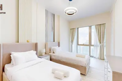 a hotel room with two beds and a window at NEXT TO BURJ AND DUBAI MALL 2 BR BEST LOCATION in Dubai