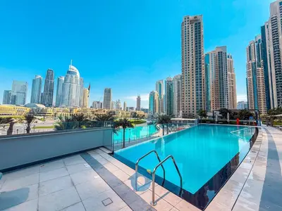 a swimming pool on the roof of a building with a city skyline at BEST SEA VIEW NEXT TO BURJ KHALIFA AND DUBAI MALL in Dubai