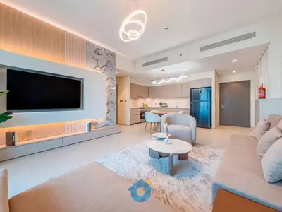 a living room with a couch and a tv at BEST SEA VIEW NEXT TO BURJ KHALIFA AND DUBAI MALL in Dubai