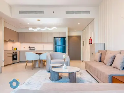 a living room with a couch and a table at BEST SEA VIEW NEXT TO BURJ KHALIFA AND DUBAI MALL in Dubai