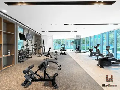 a gym with treadmills and exercise equipment in a building at 5 MINUTES BY WALK FROM BURJ ADN DUBAI MALL in Dubai