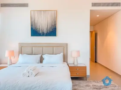 a bedroom with a bed with two white shoes on it at Best Burj Khalifa Skyline View Huge 3BR Like Home in Dubai