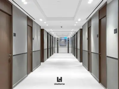 a corridor of a hospital hallway with doors and a white floor at Best Burj Khalifa Skyline View Huge 3BR Like Home in Dubai