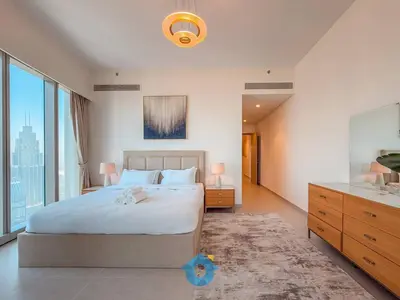 a bedroom with a large bed and a large window at Best Burj Khalifa Skyline View Huge 3BR Like Home in Dubai