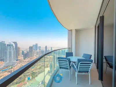 a room with a table and chairs on a balcony at Best Burj Khalifa Skyline View Huge 3BR Like Home in Dubai