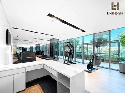 an office with a white desk and large windows at DIRECT BURJ KHALIFA ONLY 2 MINUTES AWAY in Dubai