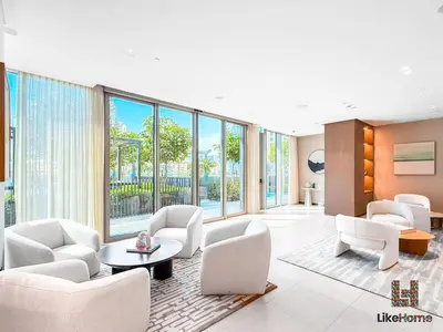 a living room with white furniture and large windows at DIRECT BURJ KHALIFA ONLY 2 MINUTES AWAY in Dubai