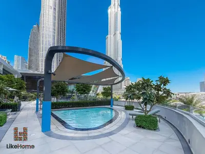 a swimming pool in a city with tall buildings at DIRECT BURJ KHALIFA ONLY 2 MINUTES AWAY in Dubai