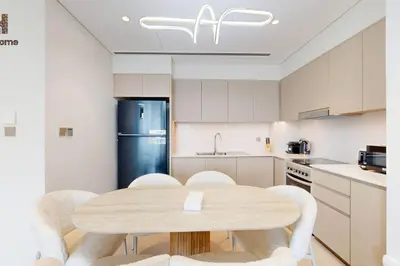 a kitchen with a table and chairs and a refrigerator at BEST VIEW IN DUBAI BURJ KHALIFA VIEW in Dubai