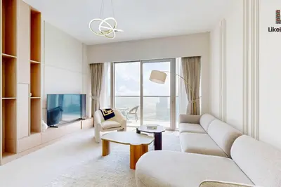 a living room with a couch and a tv at LUXURY AND BEST LOCATION 2 MINUTES BURJ KHALIFA in Dubai