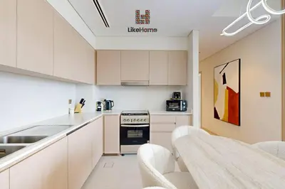 a kitchen with white cabinets and a stove top oven at LUXURY AND BEST LOCATION 2 MINUTES BURJ KHALIFA in Dubai