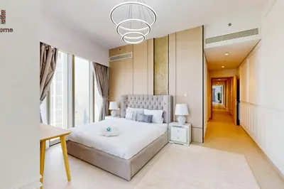 a bedroom with a large bed and a large window at Exclusive Burj Khalifa View 3BR SkyManson LikeHome in Dubai