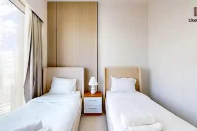 two beds sitting next to each other in a room at Exclusive Burj Khalifa View 3BR SkyManson LikeHome in Dubai