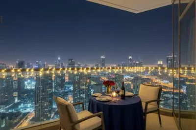 a dining room with a view of a city at night at Exclusive Burj Khalifa View 3BR SkyManson LikeHome in Dubai