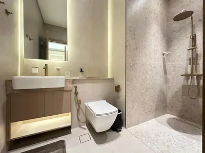 a bathroom with a sink and a toilet and a shower at Luxury 1BR - Private Balcony Pool & Smart Home - Binghatti Phantom JVC in Dubai