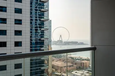 a view of the ferris wheel from a building at Gala Guests - Signature Skyview Tower High-Floor Marina Living in Dubai
