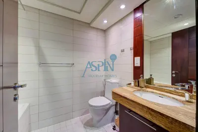 a bathroom with a toilet and a sink at Aspin Stylish Burj Views Studio-City View in Dubai