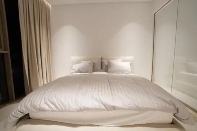 a white bed with white sheets and pillows at Spacious 2BR Near Beach Ellington in Dubai