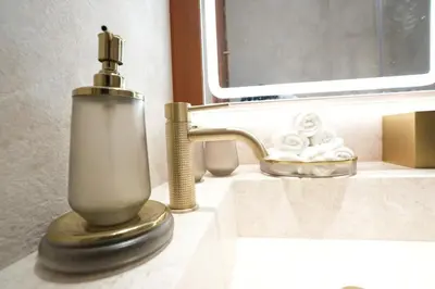 a soap dispenser sitting on a bathroom sink at Spacious 2BR Near Beach Ellington in Dubai