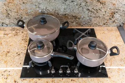 two pots sitting on top of a stove at Imperial Avenue Downtown Lux 1Bed with Balcony in Dubai