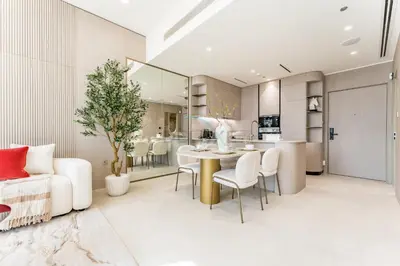 a kitchen and living room with a table and chairs at Community View, Near the Circle Mall, Pear House II by Imtiaz, Jumeirah Village Circle by Deluxe Holiday Homes in Dubai