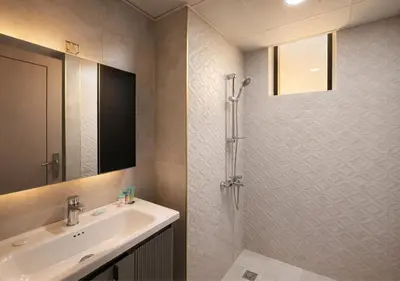 a bathroom with a sink and a shower at Stylish & Cozy 2BR Apartment in Liwan 2 in Dubai