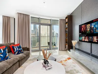 a living room with a couch and a flat screen tv at Luxurious 3-bedroom apartment downtown in Dubai
