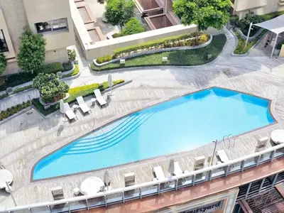 an overhead view of a large swimming pool on a building at Vogue Downtown Opera Grand near Burj Khalifa and Dubai Mall, Two Bedroom Apartment with Large Balcony and Access to all Amenities in Dubai