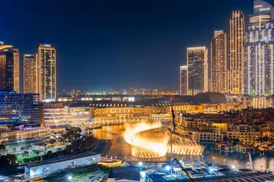 a city lit up at night with tall buildings at Vogue Downtown Opera Grand near Burj Khalifa and Dubai Mall, Two Bedroom Apartment with Large Balcony and Access to all Amenities in Dubai